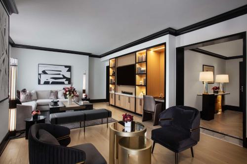 a living room with a couch and a table at Waldorf Astoria Chicago in Chicago