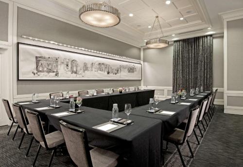a conference room with long tables and chairs at Waldorf Astoria Chicago in Chicago