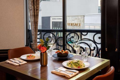 a table with two plates of food on a balcony at Waldorf Astoria Chicago in Chicago