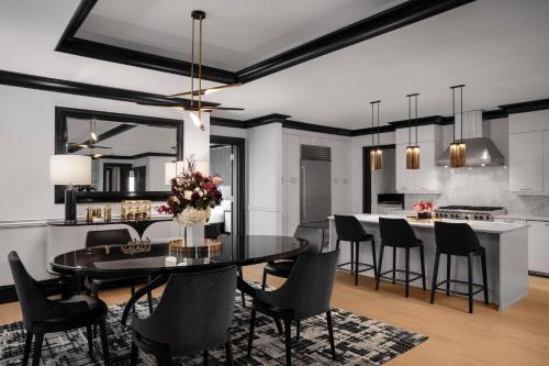 a kitchen and dining room with a table and chairs at Waldorf Astoria Chicago in Chicago