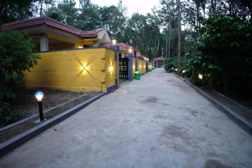 an empty road in front of a house with lights at RICHBERRY- A Premium Plantation Villa's in Suntikoppa