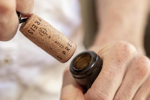 a person holding a wine cork in their hand at Aparthotel Ansitz Felsenheim in Lermoos