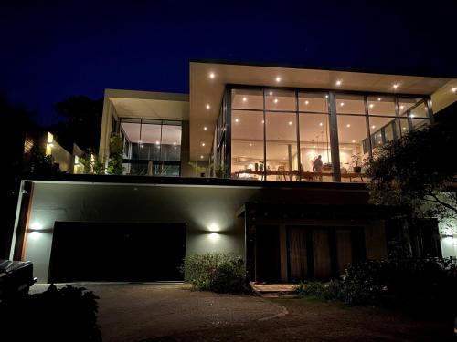 a large building with a lot of windows at night at Designer Villa with solar power at epic eco-beach in Umdloti