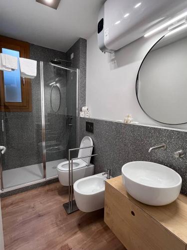 a bathroom with a toilet and a sink and a shower at Residenza Urania in Venice