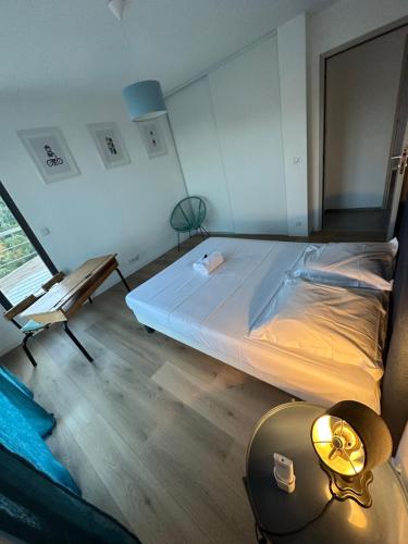a bedroom with a bed and a table with a lamp at "Villa Cavone" vue mer - piscine privée in Ventiseri