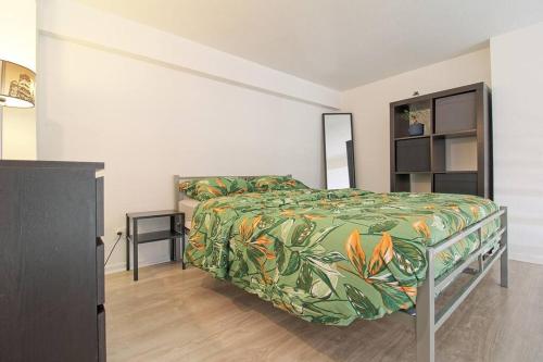 - une chambre dotée d'un lit avec un couvre-lit vert et orange dans l'établissement Le Cosy’ Moderne - Proche Musée d'Art Moderne, à Strasbourg