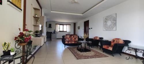 a living room with chairs and a dining room at English Point Residence Beach Apartments Mombasa in Mombasa