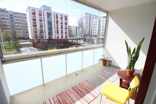 an apartment balcony with a view of a city at Pasila Studio, Near Expo in Helsinki