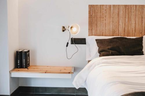 a bedroom with a bed and a table with books at El Call, Àtic con vistas al puente de Besalú in Besalú