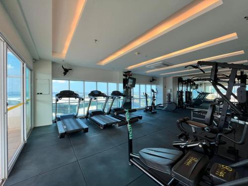 a gym with several treadmills and ellipticals in a building at Quarto de Luxo - Saint Moritz in Brasilia