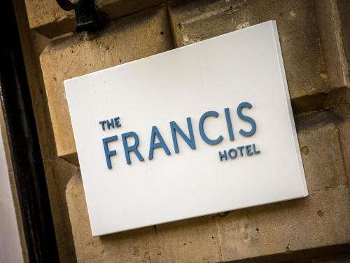 a sign for the francis hotel on a brick wall at Francis Hotel Bath in Bath