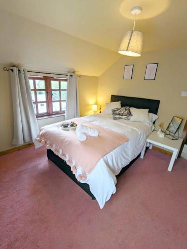 a bedroom with a large bed and a window at 3-Bed, Sleeps 6, 1 Bath, Parking, WiFi in Shalford