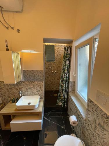 a bathroom with a sink and a shower at Casetta Beatrice Tivoli Holiday Home (British) in Tivoli
