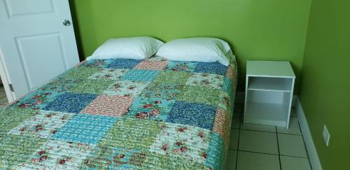 a bedroom with a bed with a quilt on it at Old Wooden Bridge Resort & Marina in Big Pine Key