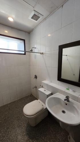 a bathroom with a toilet and a sink at Summer Hills Hotel & Villas Bandung in Bandung