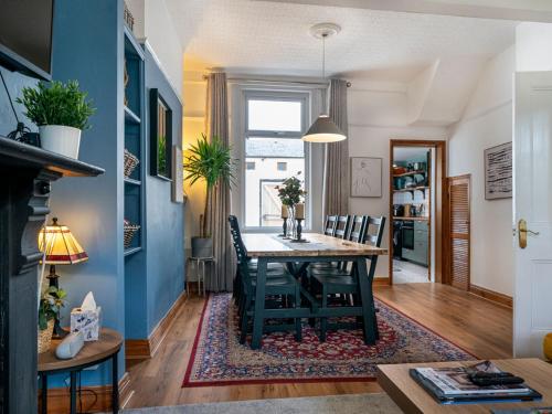 a dining room with a table and chairs at Gorgeous 4 Bedroom Home 7 Min from City Centre - Pass the Keys in Belfast