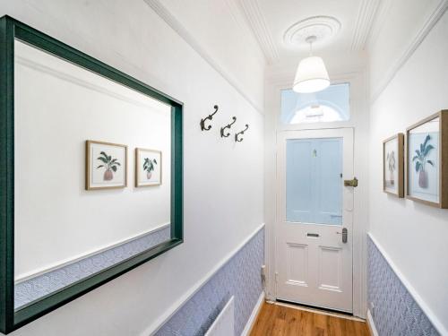a hallway with a large mirror on the wall at Gorgeous 4 Bedroom Home 7 Min from City Centre - Pass the Keys in Belfast