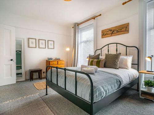 a bedroom with a bed and a window at Gorgeous 4 Bedroom Home 7 Min from City Centre - Pass the Keys in Belfast