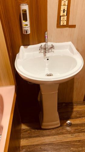 a bathroom with a white sink in a room at House Boat New Lucifer in Srinagar