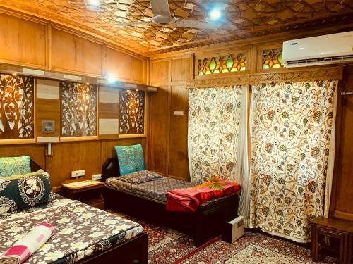 a room with two beds and curtains in a train at House Boat New Lucifer in Srinagar
