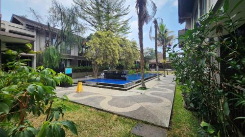 a swimming pool with a fire hydrant in a yard at Summer Hills Hotel & Villas Bandung in Bandung