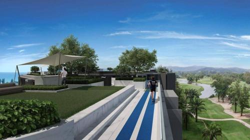 two people standing on a blue and white striped walkway at Laguna Sky Park Corner 1 Bedroom in Bang Tao Beach