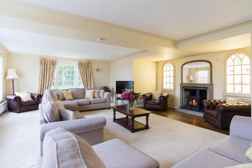 a living room with couches and a fireplace at Tapnell Manor At Tapnell Farm in Yarmouth