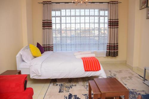 Postel nebo postele na pokoji v ubytování Edenville Studio Apartment in Ongata Rongai