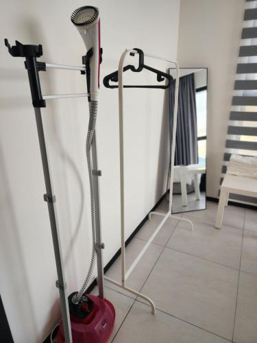 a vacuum cleaner in a room with a mirror at Urban Suite - George Town in Jelutong