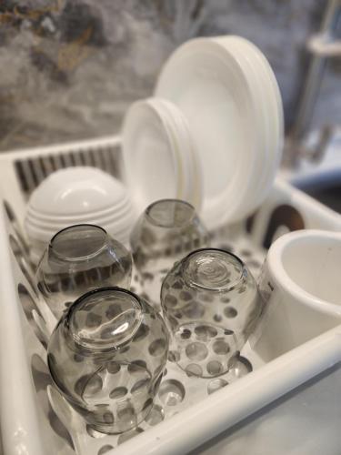a tray with dishes and cups in a sink at Urban Suite - George Town in Jelutong