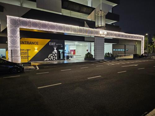 a building with an entrance to a store at night at Arte Cheras The Premium Suites by iLuxHome in Kuala Lumpur