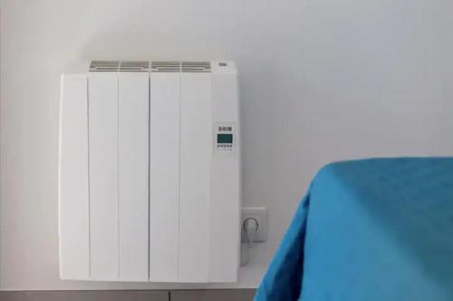 a room with a white wall with a air conditioner at Blife Faro Beach Hostel & Rooms in Faro