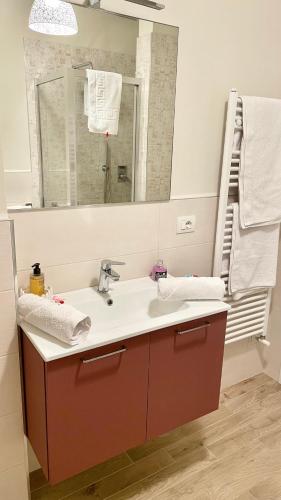 a bathroom with a sink and a mirror at Appartamento Leonardo in Prato