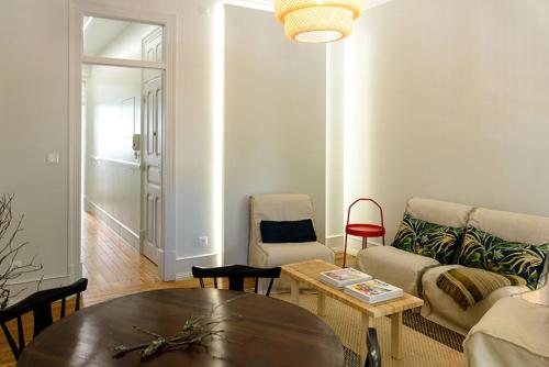 a living room with a couch and a table at Lisbon Evergreen Apartment in Lisbon