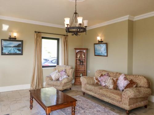 a living room with two couches and a coffee table at Ocean View in Adrigole