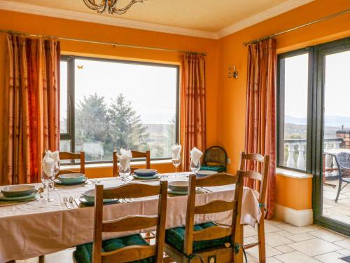 a dining room with a table and a large window at Ocean View in Adrigole