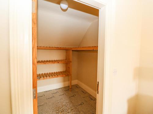 a room with a closet with wooden shelves at Ocean View in Adrigole