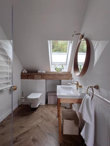 a bathroom with a sink and a mirror at Noclegi Panorama in Ustrzyki Dolne