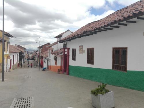 an empty street in a town with buildings at Casita de Piedra in Bogotá