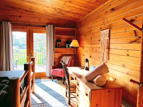 a wooden cabin with a desk and a window at NewVida Preserve in Wilmington