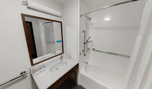 a white bathroom with a sink and a mirror at Hampton Inn Majestic Chicago Theatre District in Chicago