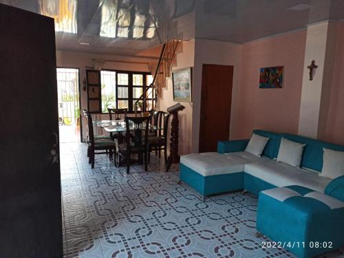 a living room with a blue couch and a table at Casa Eguis in Gaira