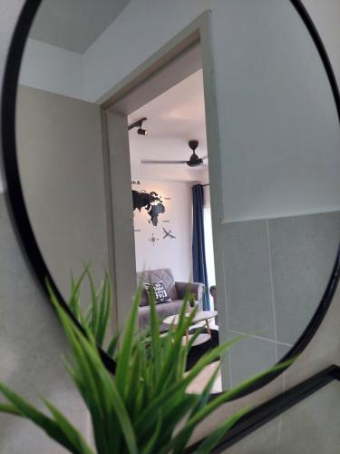 a mirror in front of a living room with a couch at KLIA Travel Homestay - 3R 2B - WIFI & NETFLIX in Sepang