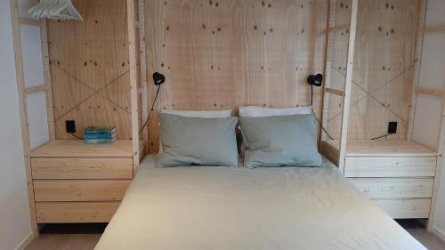 a bed with a wooden headboard in a room at Logies Prinsewyk De Knipe/Oranjewoud 