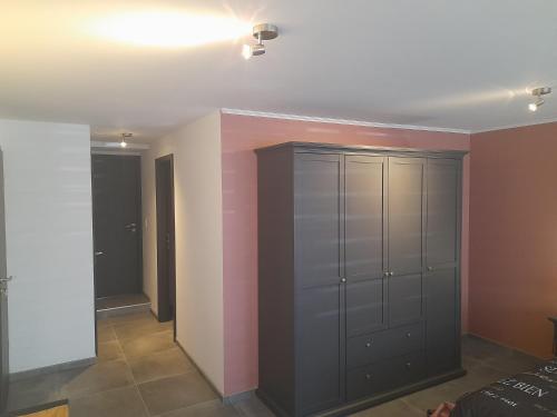 a room with a closet with gray cabinets at Chez Francis in Verviers