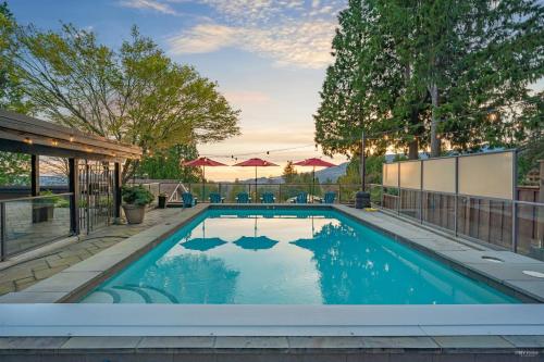 a swimming pool with blue water in a yard at Private Bedroom, Bathroom, Shared Outdoor Pool, Hot Tub in North Vancouver
