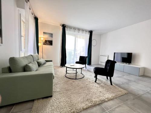 a living room with a couch and a table at !NEW! Disney/Paris - 50m RER A in Noisy-le-Grand