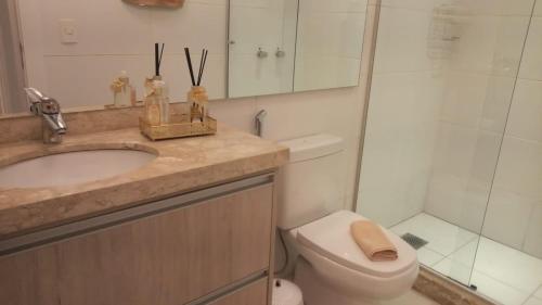 a bathroom with a sink and a toilet and a shower at Altos da Bela Vista Gramado centro locação de temporada in Gramado