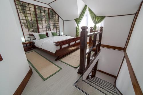 a bedroom with a bed and a mirror at Casa Lily - Japanese Retreat in Sighişoara