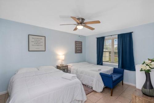 a bedroom with two beds and a ceiling fan at Quiet apartment in Iowa, LA in Iowa